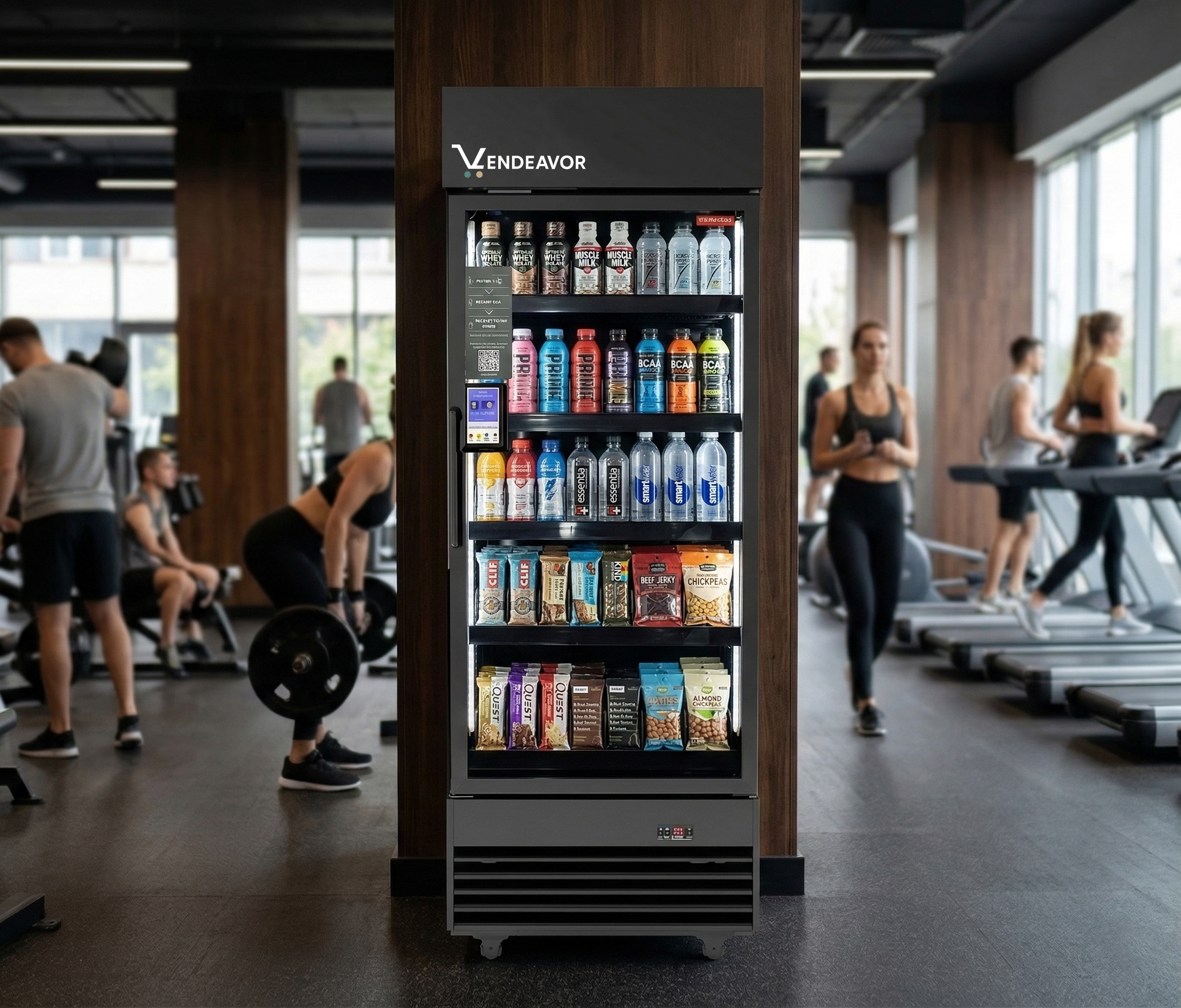 A high-end Vendeavor Smart Hub stocked with premium recovery shakes, electrolyte drinks, and healthy protein snacks, centrally located in a modern, active gym environment to improve member retention.